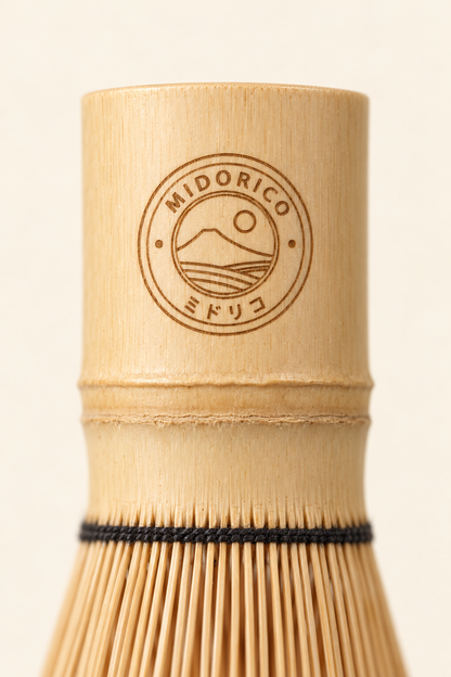 Close-up of the laser-engraved Midorico emblem on the bamboo whisk handle